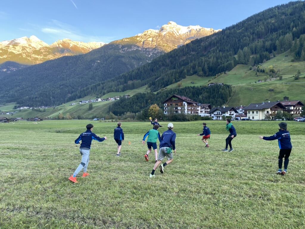 Athletes playing games on a mountain field